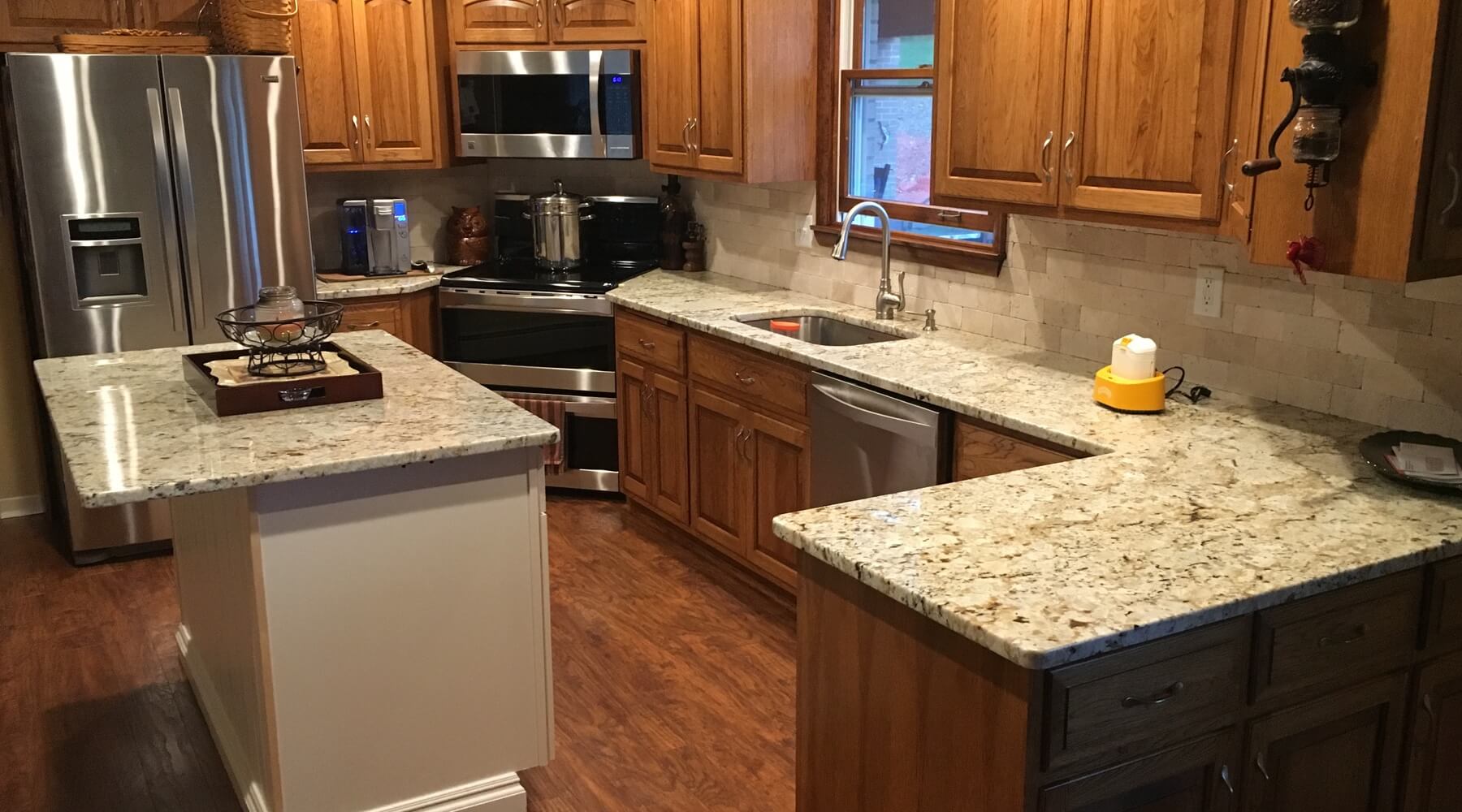 Kitchen with dark cabinents and granite tops